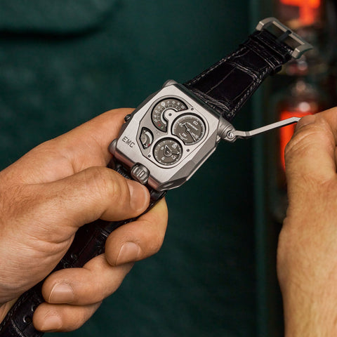 Close-up of the URWERK EMC's winding mechanism, showcasing the manual-winding generator and intricate craftsmanship in action.