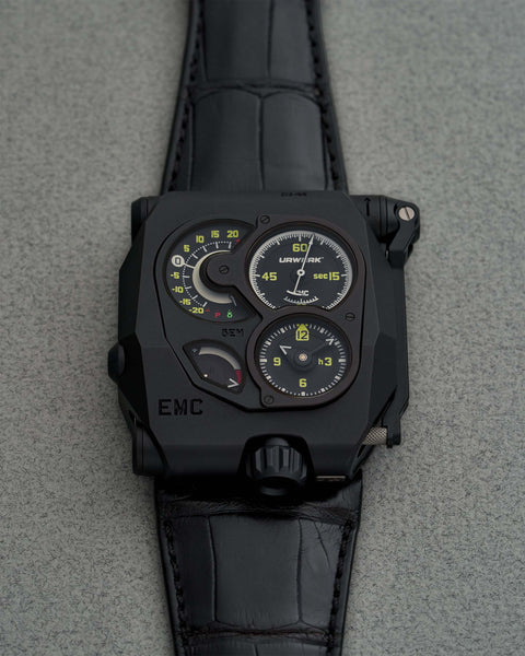 Front view of the URWERK EMC Black timepiece, showcasing its matte black finish, bold angular case, and chronometric monitoring system—a cutting-edge creation for luxury watch collectors