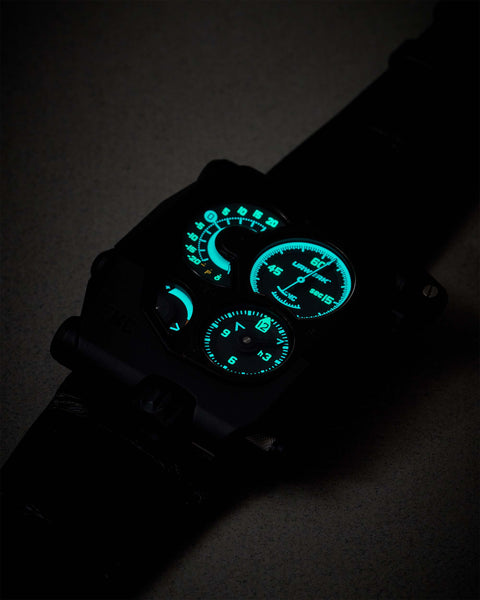 URWERK EMC Black dial glowing in the dark, highlighting its vibrant lume on the hour markers and hands—a striking feature of this precision-engineered Swiss luxury watch.